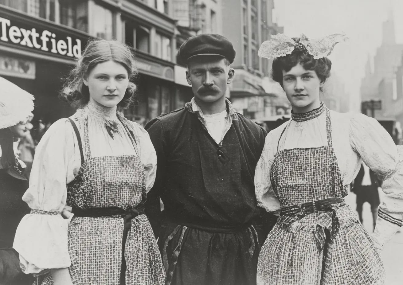 An_old_photo_shows_people_in_traditional_costumes_on_the_str, variant 1